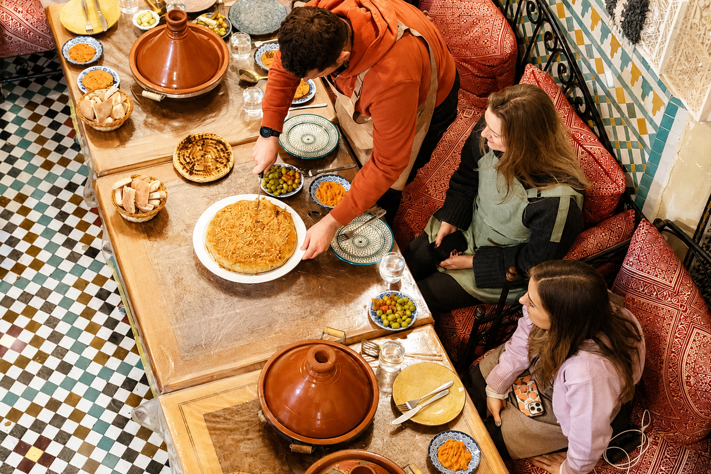 A grandmother and grandchild choosing herbs and spices at a Marrakech souk stall, Morocco.