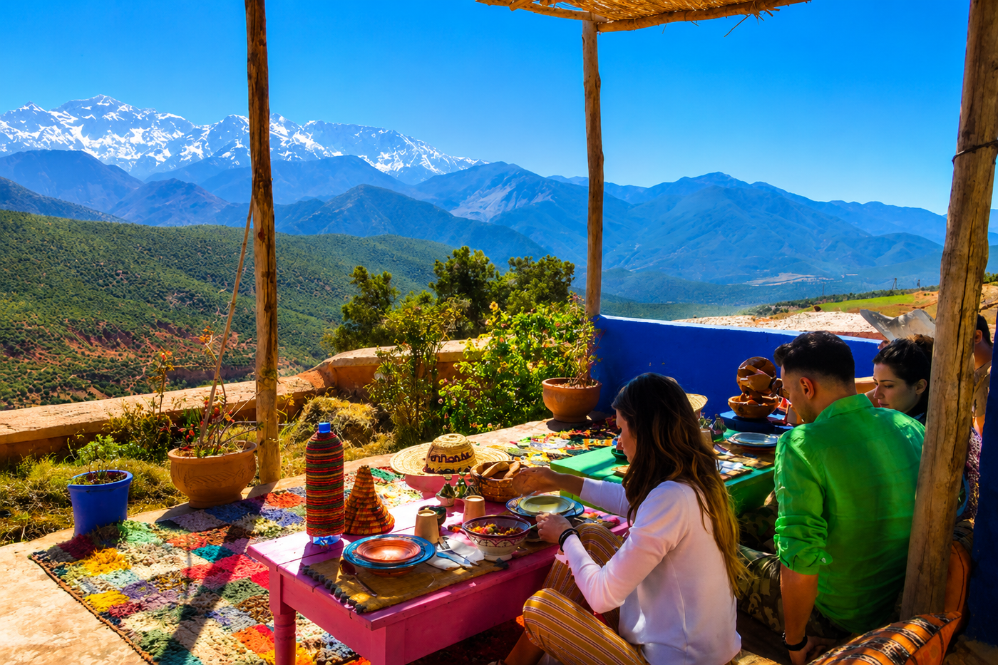 An Amazigh host setting out olives, mint and tea on a low table in an Atlas village, Morocco.