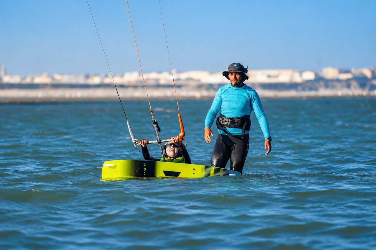 A surf instructor laying out equipment on the beach at first light in Essaouira, Morocco.