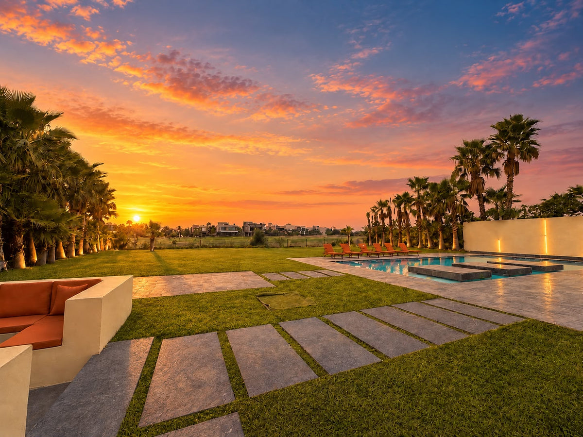 Sunset over the lawn and pool of a private villa in Marrakech