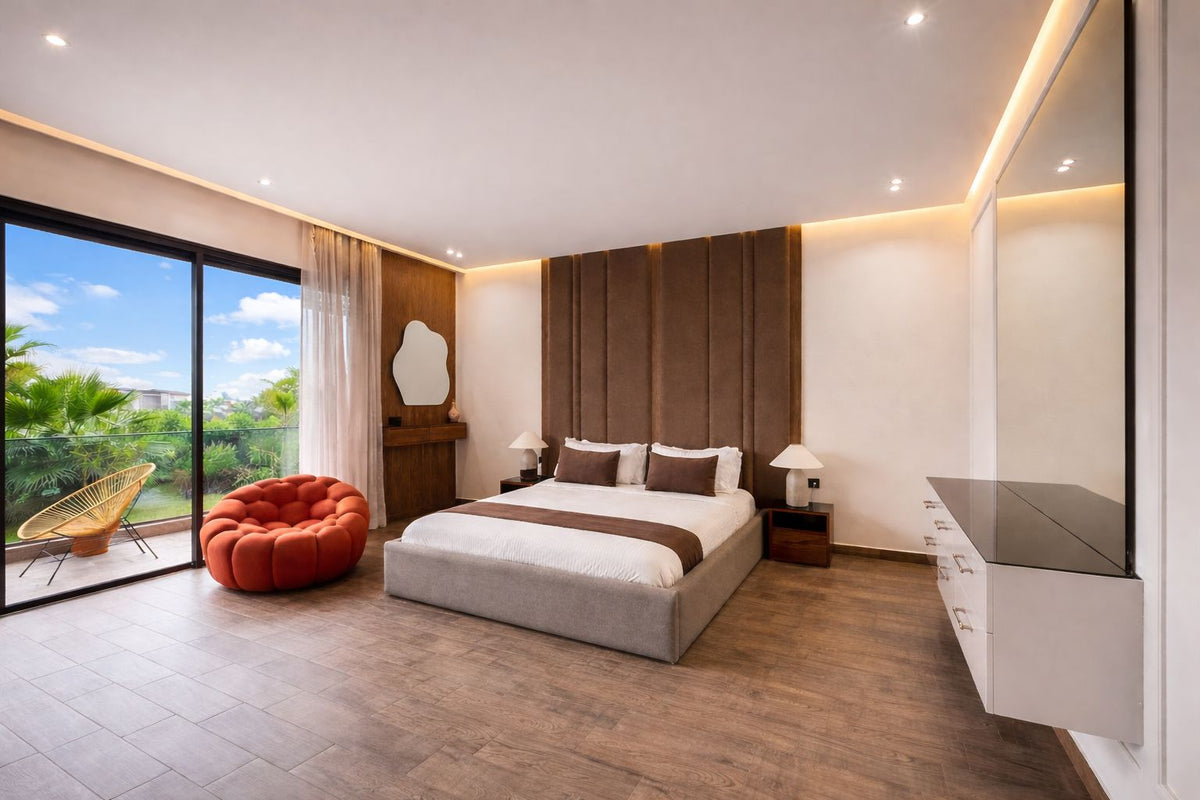 A bedroom opening onto a terrace and palm trees