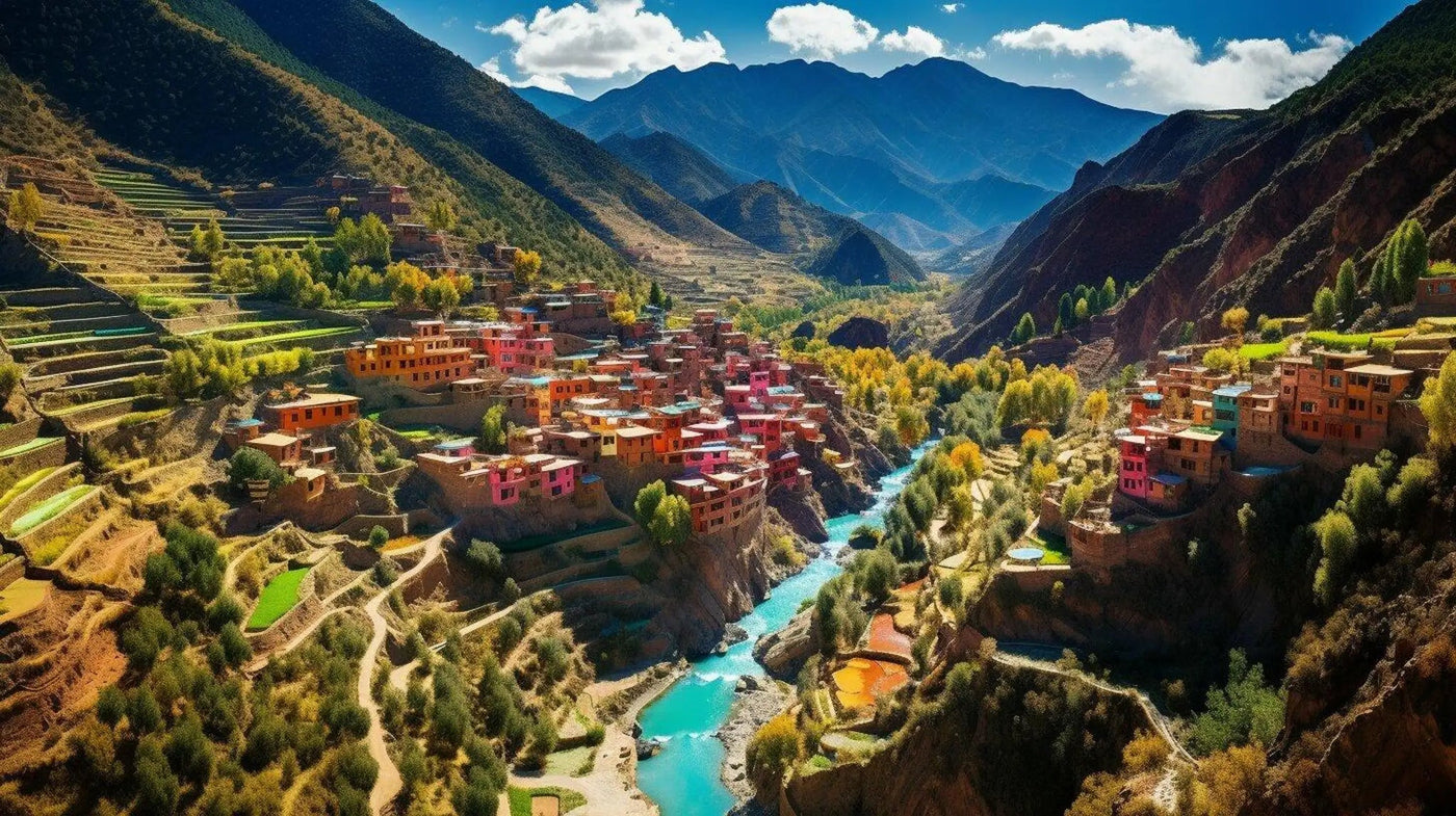Terraced hillsides and a turquoise river winding between colourful houses in a mountain valley