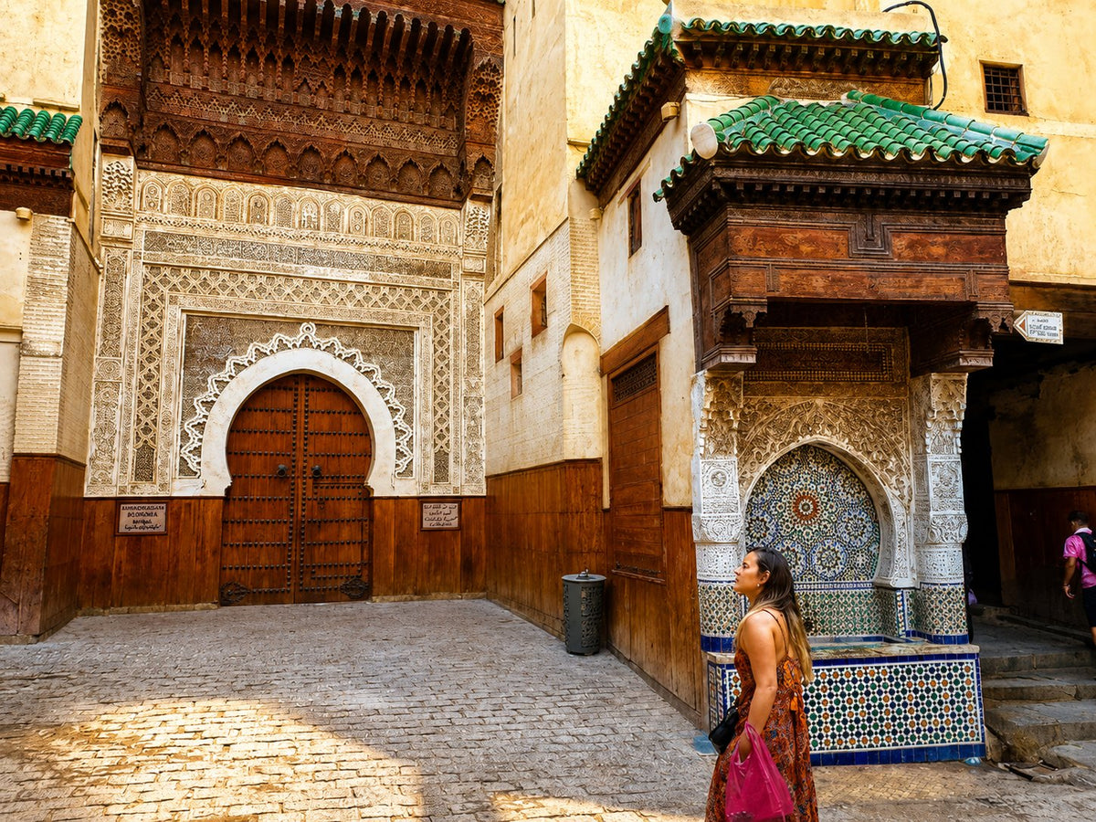 A zellige master splitting a glazed tile chip with a chisel in Fes, Morocco.