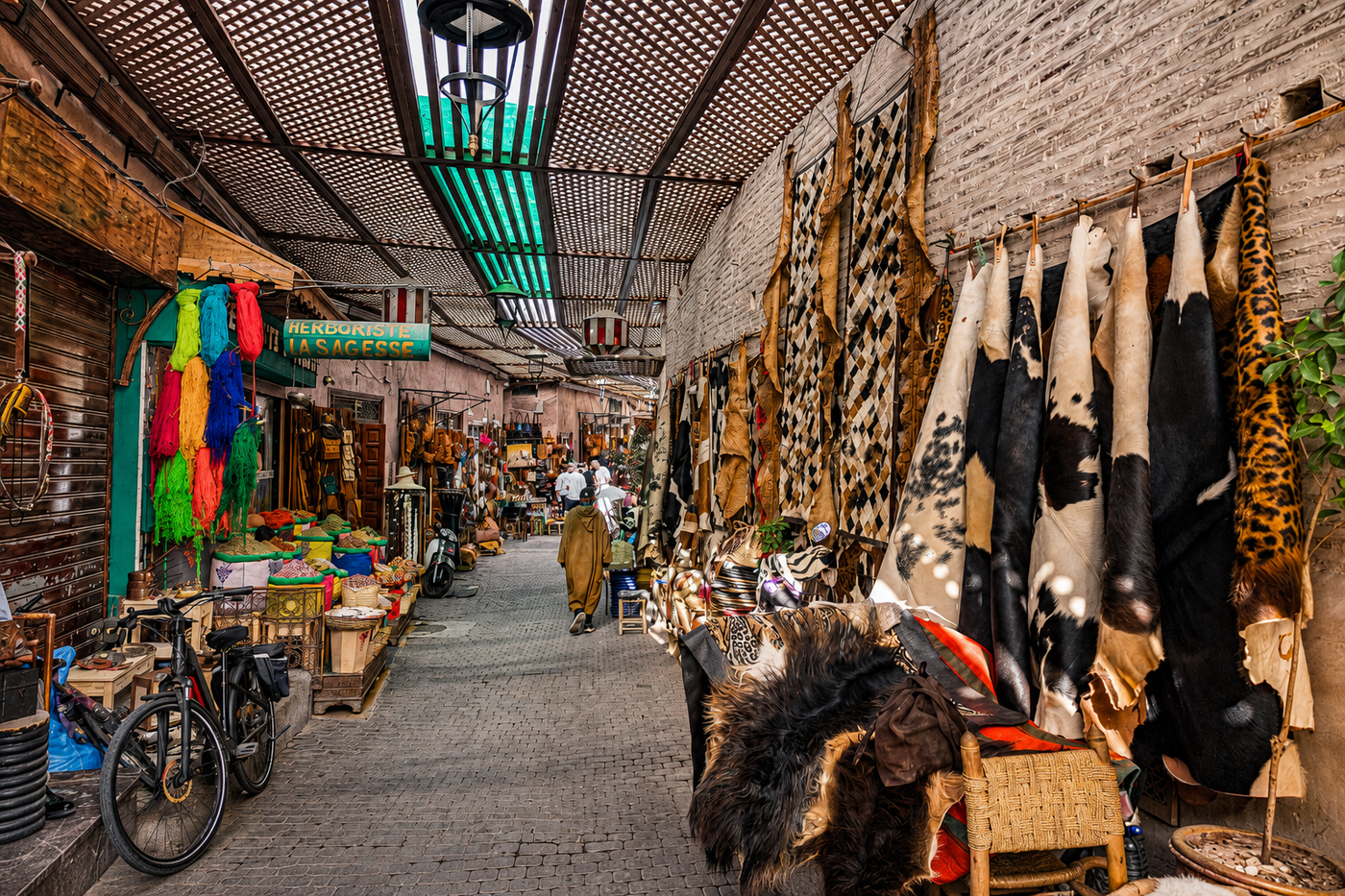 A local guide talking with a food-stall vendor he knows at night in Jemaa el-Fna, Marrakech.