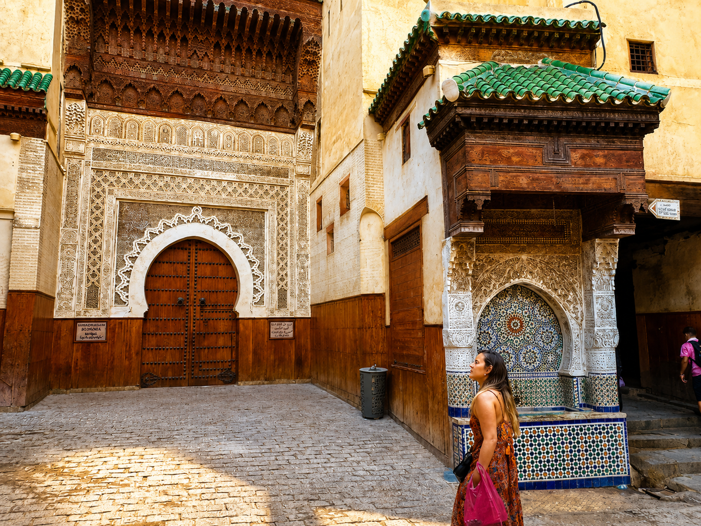 A zellige master splitting a glazed tile chip with a chisel in Fes, Morocco.