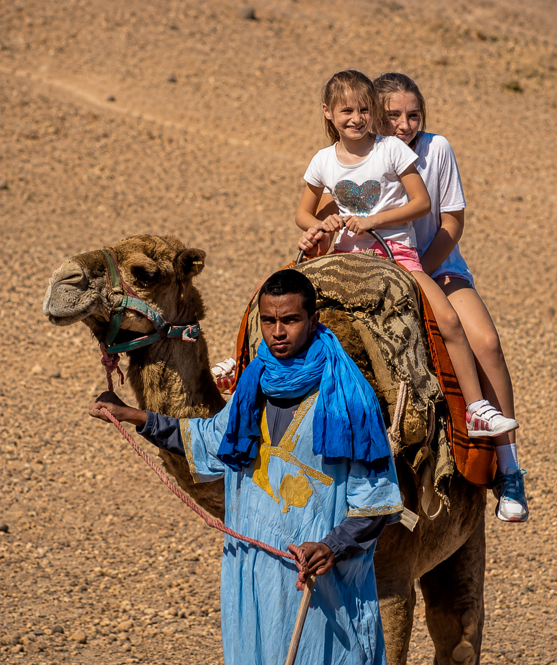 Teenagers riding a buggy across the Agafay stone desert near Marrakech, Morocco.