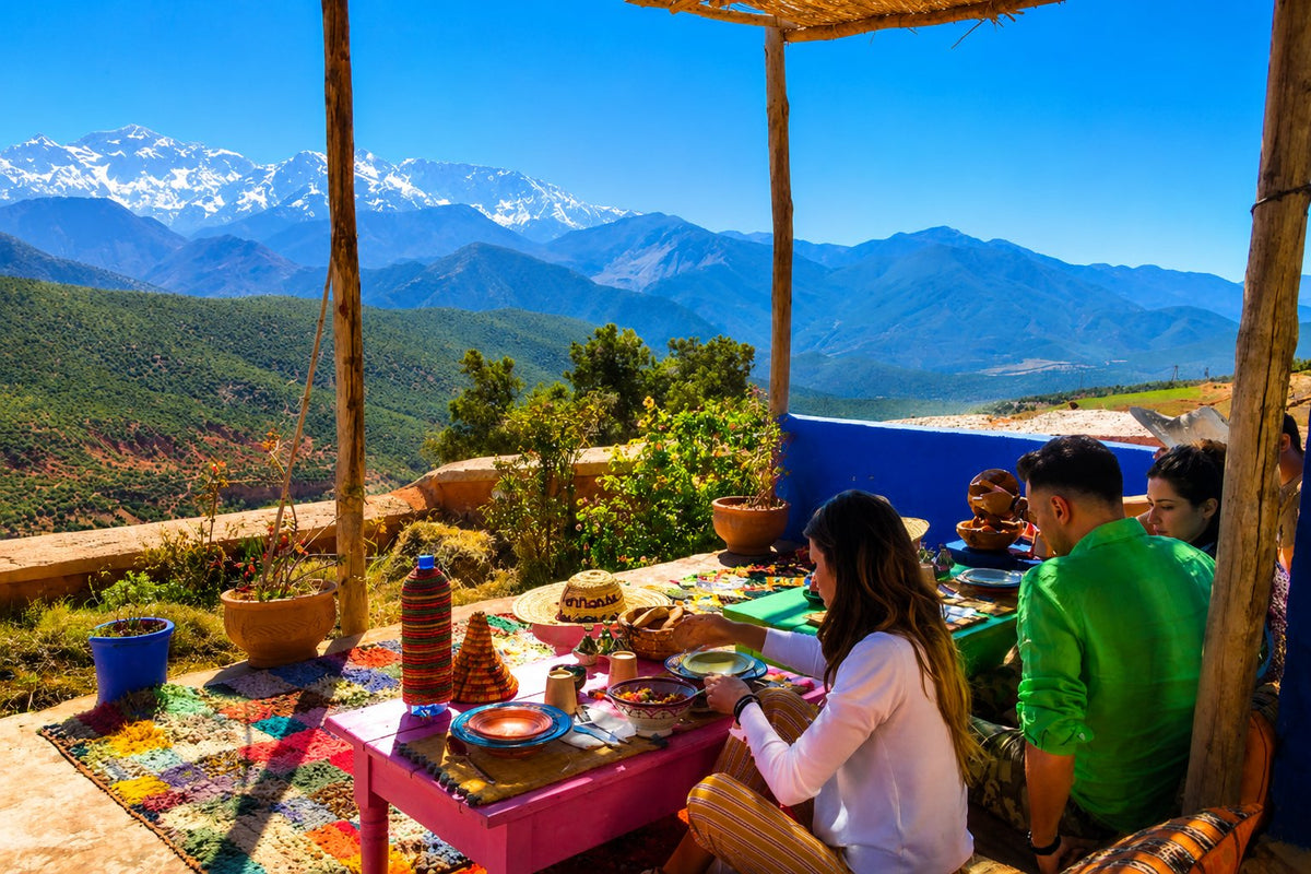An Amazigh host setting out olives, mint and tea on a low table in an Atlas village, Morocco.