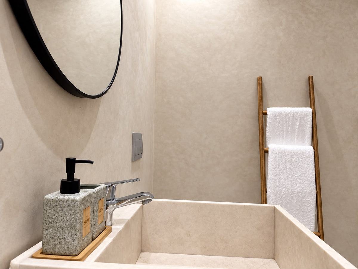 A stone basin and a towel ladder in a villa bathroom