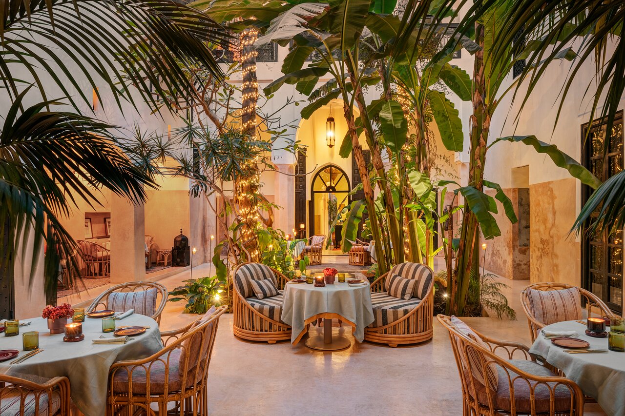 A child looking up at the open sky of a riad courtyard in the Marrakech medina, Morocco.