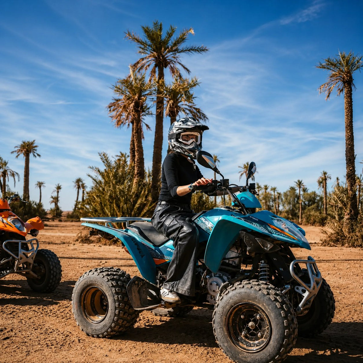 Rider in a helmet on a blue quad bike among palm trees under a clear sky